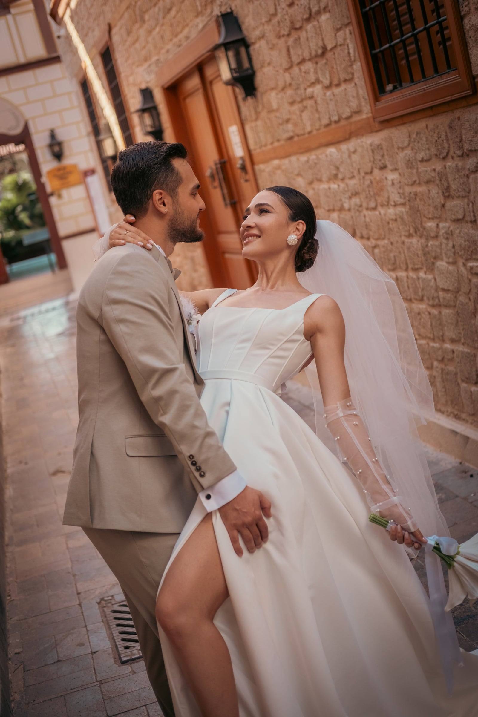 Bride and groom walking along an old-town street