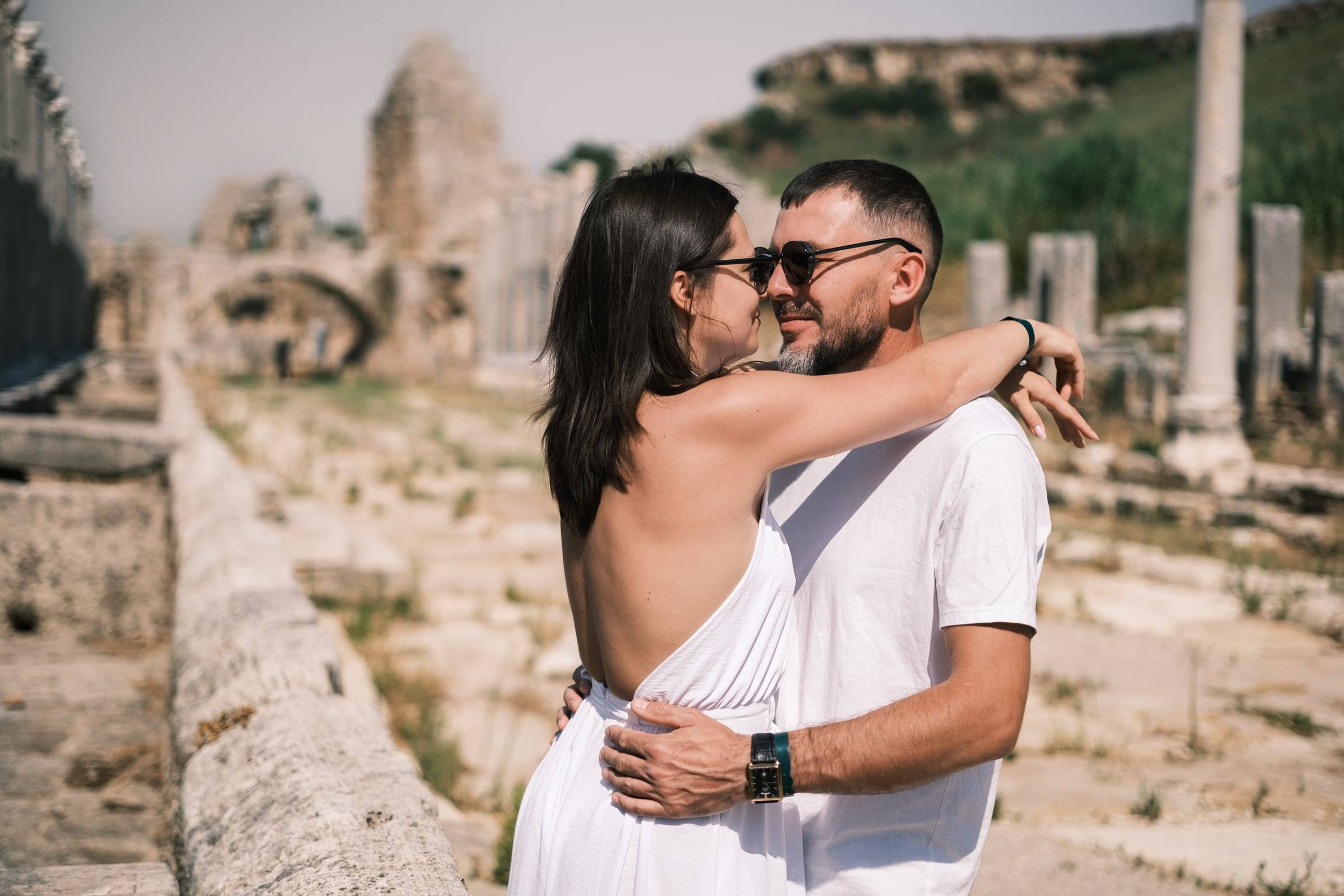 Couple hugging on the ancient colonnaded street of Perge