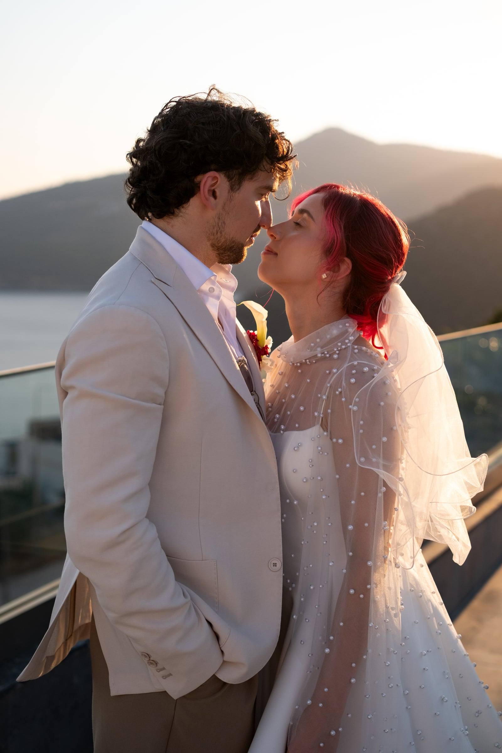 Bride and groom facing each other at sunset