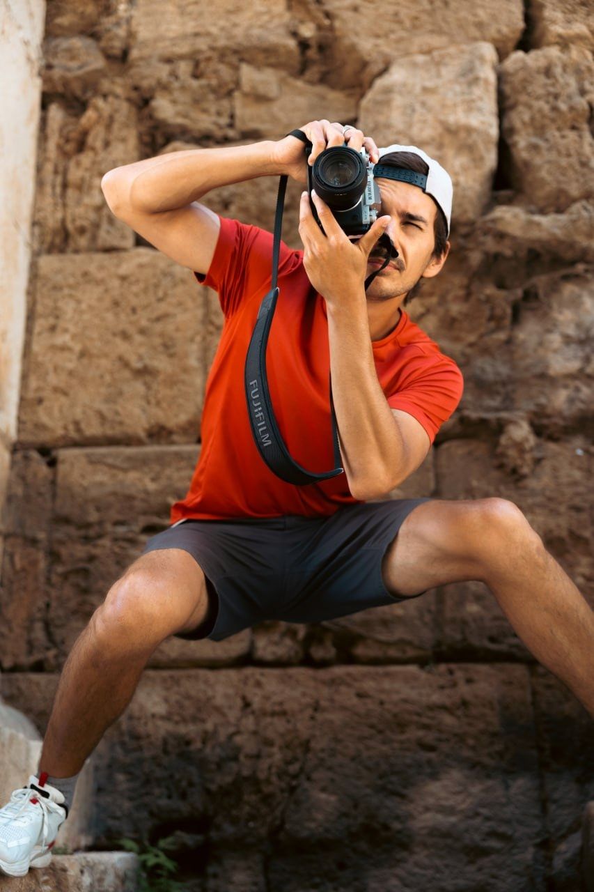 Oleg with his camera by an ancient stone wall in Antalya